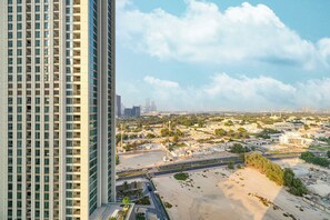A high-rise building with a view of a cityscape, including roads and greenery. - Luxury Stays @ Downtown Views 2 with UniDwellers Holiday Homes (Dubai)