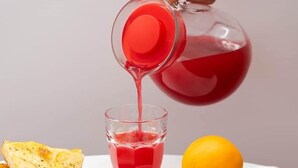 A breakfast setting with a glass of red juice, a croissant, and various breakfast items. - Flamingo affittacamere - Camera 4 (Matera)