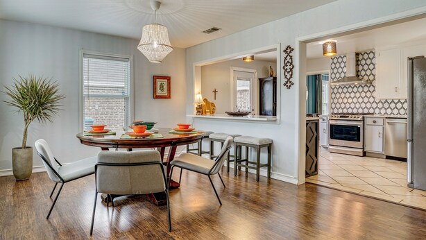 A dining area with a round table, chairs, and a potted plant. - Family + Pet Friendly: Fort Worth Home Near TCU! (Fort Worth)