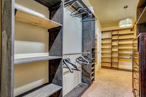 A walk-in closet with open shelves, a clothing rack, and a hanging light fixture. - Family + Pet Friendly: Fort Worth Home Near TCU! (Fort Worth)