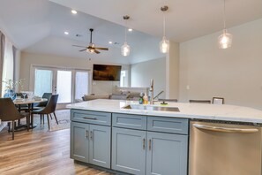 A modern kitchen with a large island, stainless steel appliances, and pendant lighting. - 3 Mi to Dtwn Houston: Dual-Unit Home w/ Yard! (Houston)