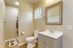 A bathroom with a toilet, sink, mirror, and a small window. - 2 Mi to Great Smoky Mtns NP! Cozy Cabin Retreat (Townsend)