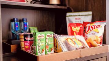 A variety of packaged food items including cereal, snacks, and beverages.
