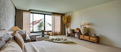 A modern hotel room with a large bed, a desk, a chair, and a view of the outdoors.