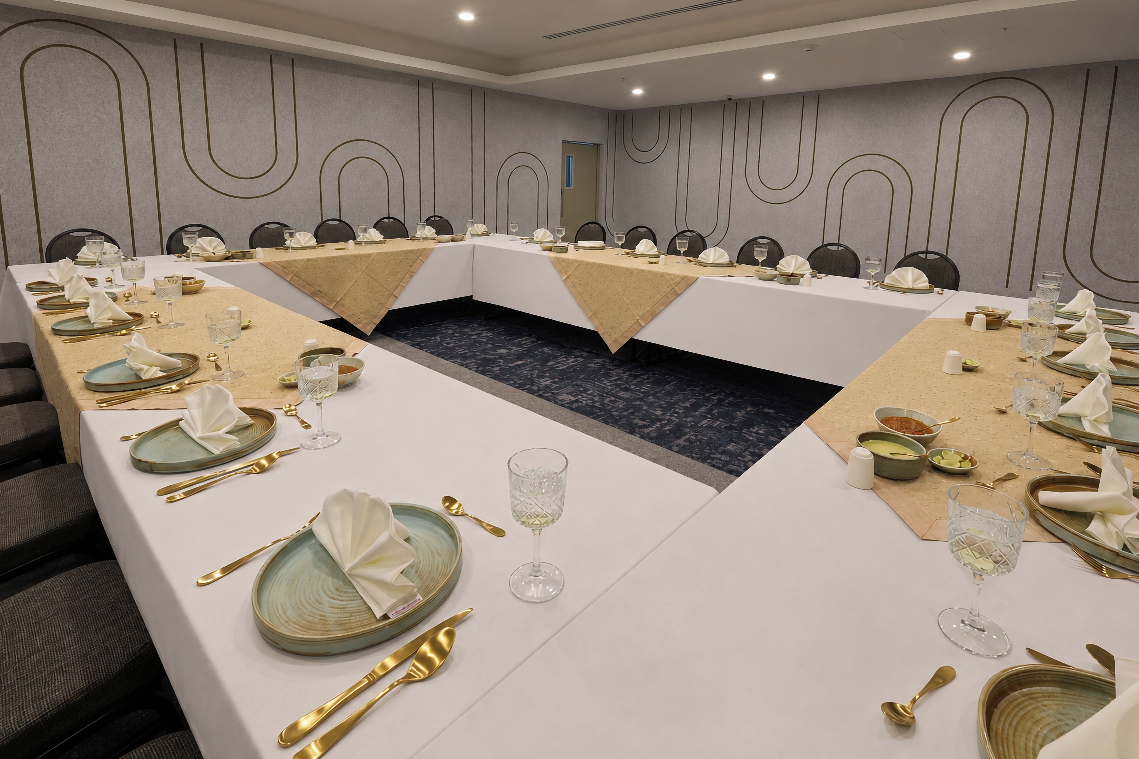 A conference room with a long table, chairs, and a central aisle.