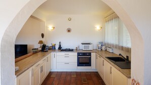 A kitchen with a microwave, oven, sink, and a television. - Moulin St Jean - Nature in the heart of the village (Tourrettes-sur-Loup)
