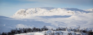 A snowy mountain landscape with a clear sky.