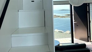 Una escalera que lleva a un balcón con vista al mar.