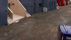 A row of modern buildings with metal roofs and wooden staircases.