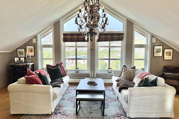Relaxing living room with a beautiful view, perfect for enjoying both indoor comfort and the outdoor nature.