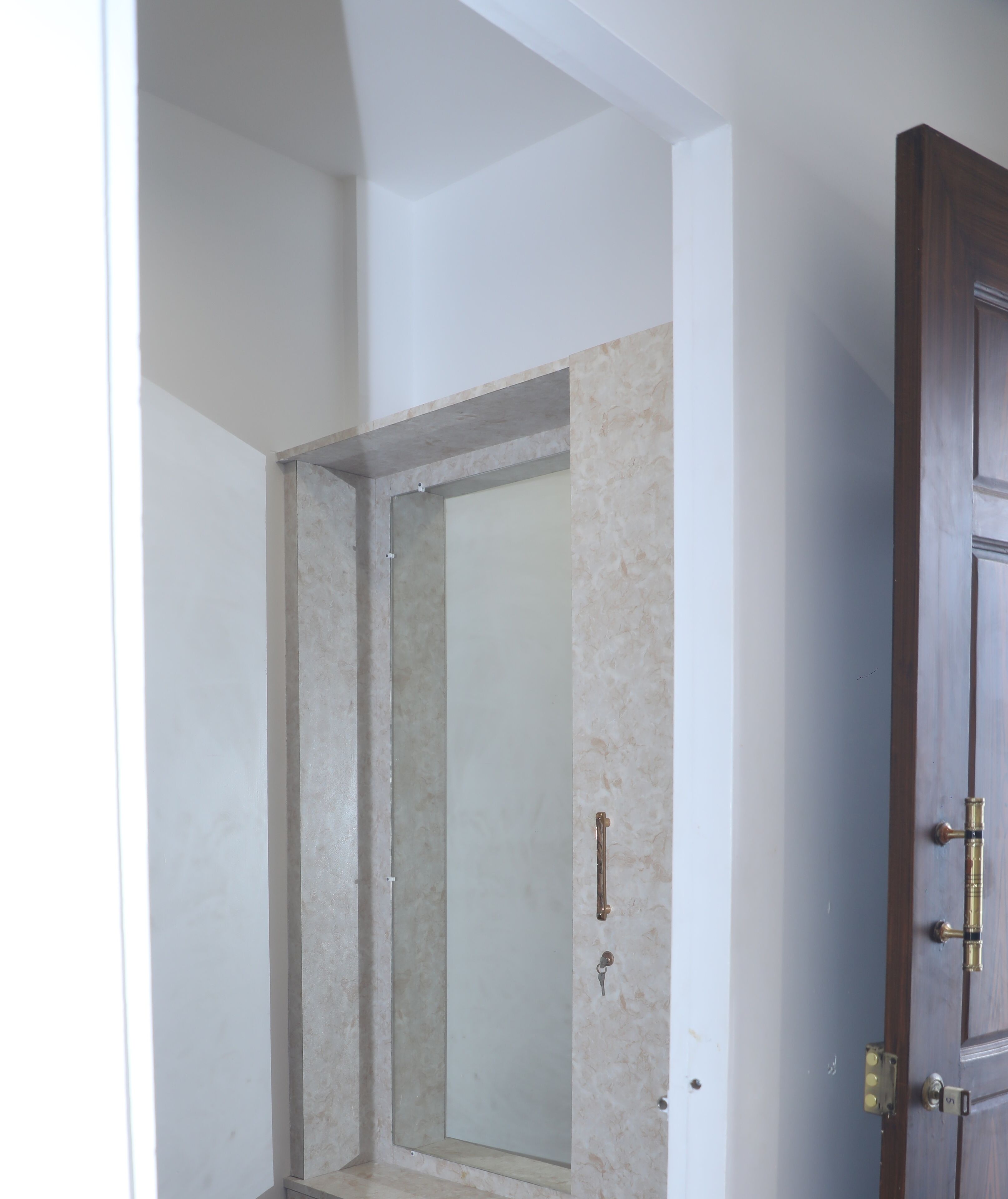 A room with a shower, a door, and a wall.