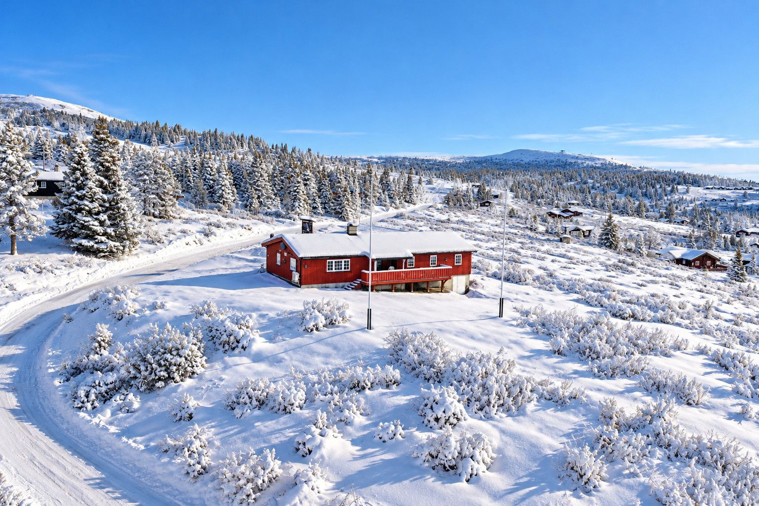 A snow-covered landscape with a red cabin and a clear sky.