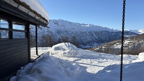 A snow-covered mountain landscape with a building featuring a number '9' on its door.