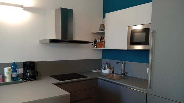 A compact kitchenette with a microwave, coffee maker, and a small countertop. - COMFY & COZY, in the heart of Chiavari, cozy two-room special and perfect" (Chiavari)