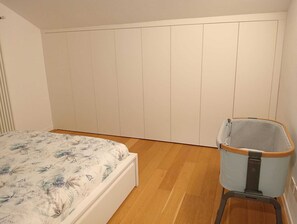 A bedroom with a bed, a wardrobe, and a storage unit. - COMFY & COZY, in the heart of Chiavari, cozy two-room special and perfect" (Chiavari)