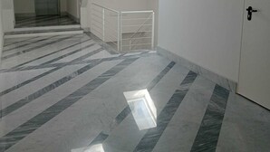 A hallway with a tiled floor, a door, and a staircase with a railing. - COMFY & COZY, in the heart of Chiavari, cozy two-room special and perfect" (Chiavari)
