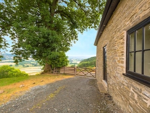 A stone building with a gravel path leading to a wooden gate. - Bishop's Castle Barn, Bishop's Castle (Bishop's Castle)