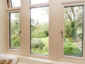 A window with a view of a garden.