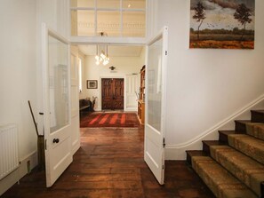A hallway with wooden flooring, a double door, a staircase, and a painting on the wall. - Caynham Court, Caynham, Ludlow (Ludlow)