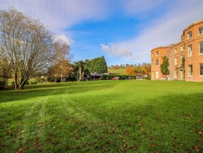 A grassy lawn with a building in the background. - Caynham Court, Caynham, Ludlow (Ludlow)