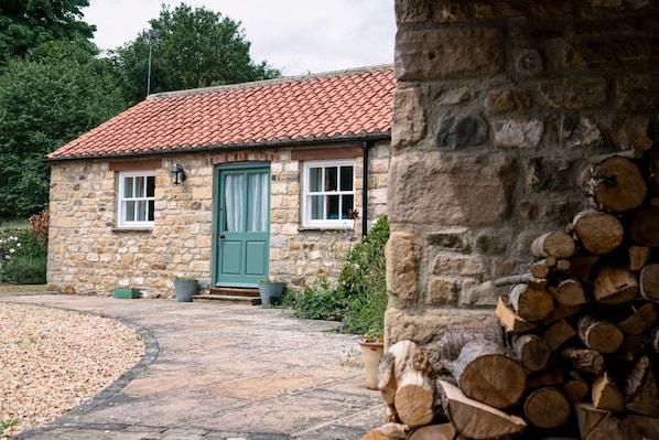 A stone building with a tiled roof, a green door, and a gravel pathway leading to it. - Alwent Mill, Staindrop (Darlington)