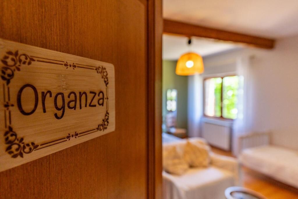 A wooden door with a sign reading 'Organza.'