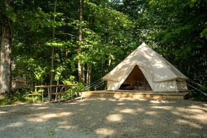 A tented accommodation with a simple layout, surrounded by dense forest. - Tranquil Forest Oasis: Fabulous Bell Tent for Two near Tobermory, Canada (Northern Bruce Peninsula)