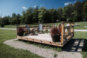 A wooden deck with seating and potted plants.