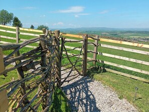 A rustic wooden gate with a gravel path leading to a green field. - The Herdsman, Barnoldswick (Barnoldswick)