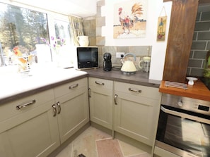 A kitchen with a microwave, kettle, coffee maker, and oven. - The Museum, Nenthead, Cumbria. (Alston)
