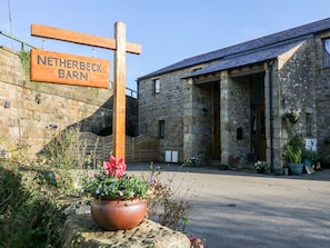 A stone building with a sign reading 'NETHERBECK BARN'.