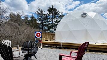 A geodesic dome structure, outdoor seating, and a target sign.