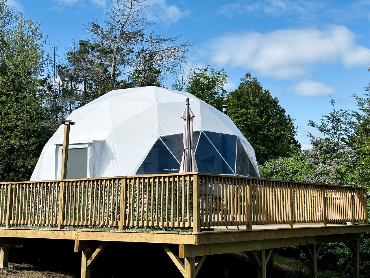A dome-shaped structure with a wooden deck and a window.