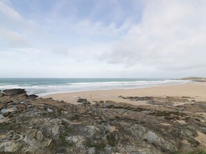 A rocky beach with a sandy shore and the ocean in the background. - Newquay Fistral Beach View, Newquay (Newquay)