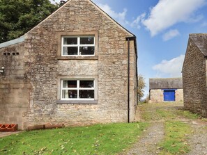 A stone building with two windows and a blue door. - The Duck House, Brampton, Cumbria (Carlisle)