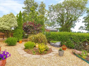 A garden with a variety of plants and a stone pathway. - Estuary View, Warkworth (Morpeth)