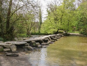 A natural setting with a stone bridge over a stream, surrounded by trees. - Jack's Nest, South Molton (South Molton)