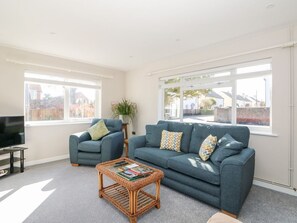 A living room with a sofa, armchair, and a coffee table. - Sunnyside, Wells-Next-The-Sea (Wells-next-the-Sea)
