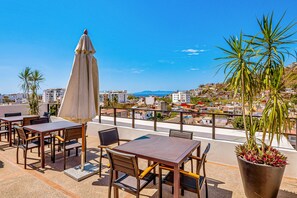Outdoor dining - 2nd-floor condo with heated outdoor pool, grills, balcony, W/D, AC (Puerto Vallarta)