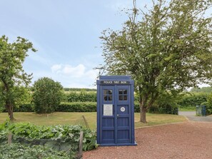 A police box in a garden setting. - Buttercups at Midway, Kington (Worcester)