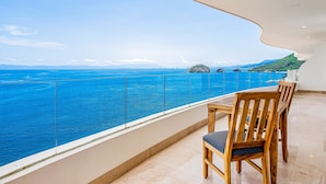 A balcony with a view of the sea and a distant island. - Blue Horizon 804 | 2BR/2BA Puerto Vallarta | Ocean View, Pool, Gym (Puerto Vallarta)