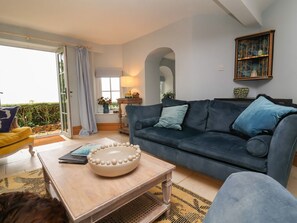 A living room with a sofa, a coffee table, and a lamp. - Rookery Cottage, Lynton (Lynton)