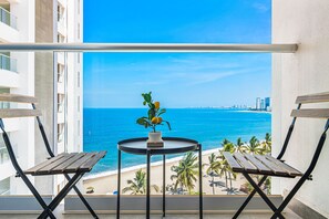 Outdoor dining - Modern oceanfront studio with breathtaking sunsets, heated pools & beach access (Puerto Vallarta)