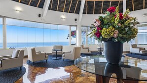 A spacious lobby with a glass coffee table, comfortable seating, and a large potted plant. - Stunning oceanview suite with cliffside infinity pool, terrace & gourmet kitchen (Puerto Vallarta)