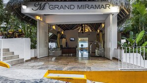 The entrance to Grand Miramar with a stone pathway leading to the lobby, surrounded by tropical plants. - Stunning oceanview suite with cliffside infinity pool, terrace & gourmet kitchen (Puerto Vallarta)