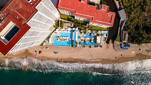 An aerial view of a coastal hotel with a red-roofed building, a pool area, and a beach. - Summer Deal 1BR Puerto Vallarta condo w/ pool, gym (Puerto Vallarta)