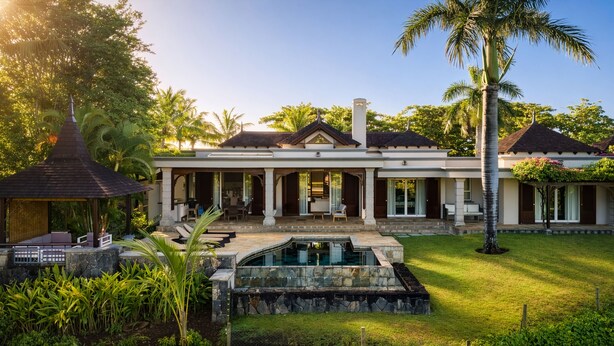 A two-story house with a swimming pool, covered patio, and lush garden. - Peaceful 4-Bedroom Villa / Infinity Pool & Garden View (Bel Ombre)
