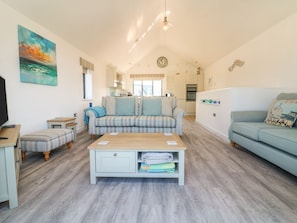 A living room with a sofa, a coffee table, and a television. - Seaquel, Westward Ho! (Bideford)