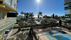 A residential area with a pool, palm trees, and a clear sky. - Terrasol SAN Gerardo 2-1-3 Frontal AL MAR (Velez-Malaga)