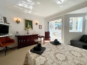 A hotel room with a bed, a desk with a computer, a chair, a sofa, and a window with a view. - Terrasol Plazamar 3-6 (Velez-Malaga)